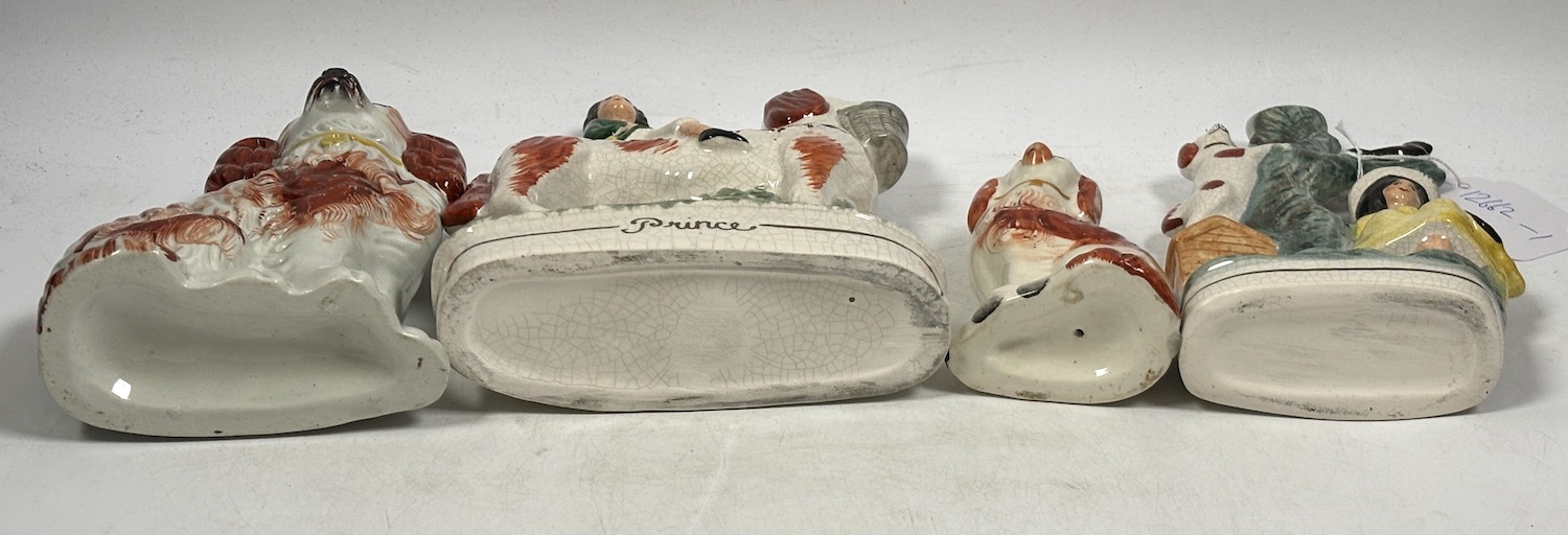 Two Staffordshire spaniels and two pottery groups, largest 19cm high